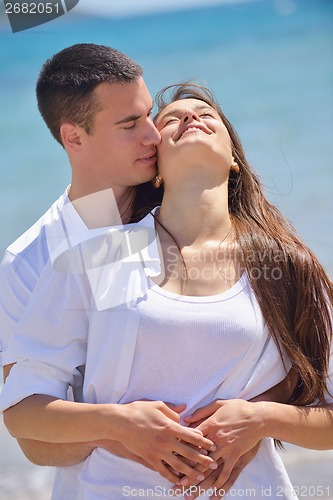 Image of happy couple have fun on the beach
