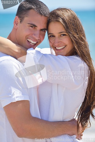Image of happy couple have fun on the beach