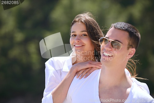 Image of happy couple have fun on the beach