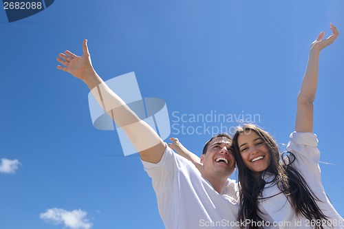 Image of happy couple have fun on the beach