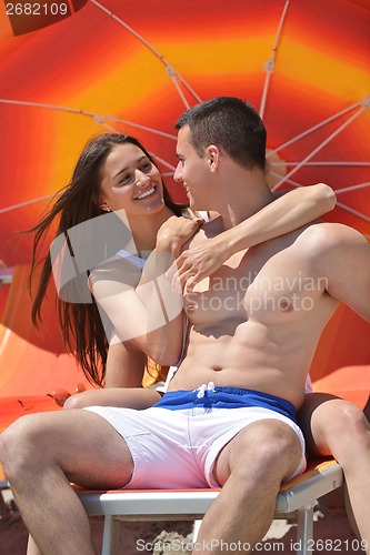 Image of happy couple have fun on the beach