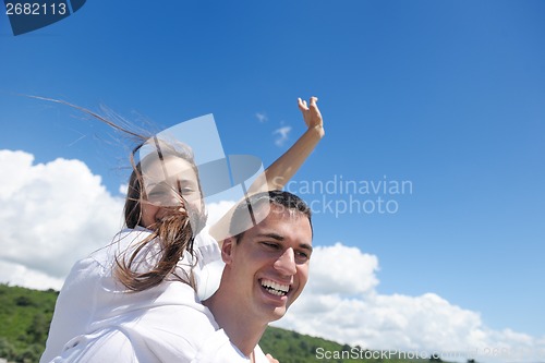 Image of happy couple have fun on the beach