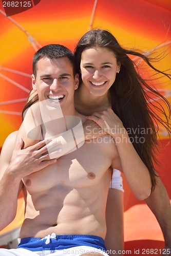Image of happy couple have fun on the beach