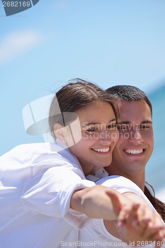 Image of happy couple have fun on the beach