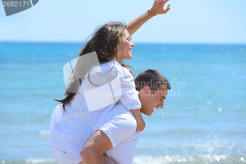 Image of happy couple have fun on the beach