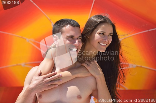 Image of happy couple have fun on the beach