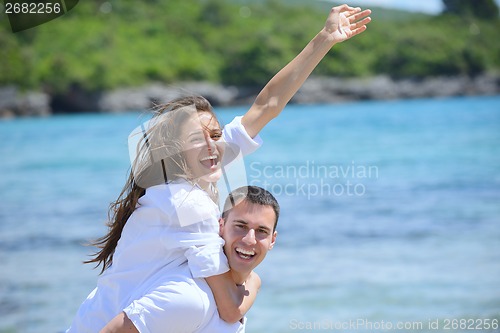 Image of happy couple have fun on the beach