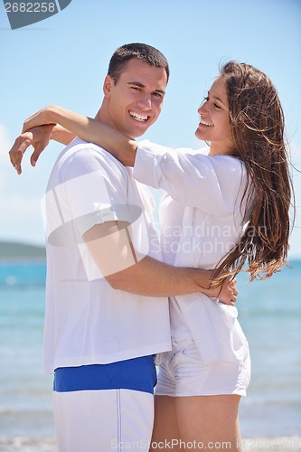 Image of happy couple have fun on the beach