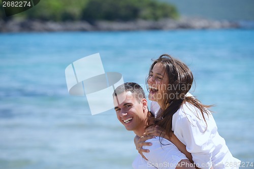 Image of happy couple have fun on the beach