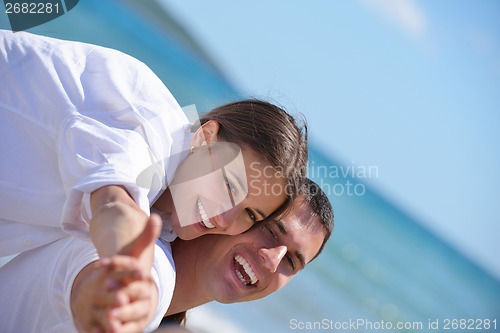 Image of happy couple have fun on the beach