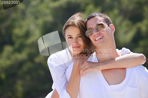 Image of happy couple have fun on the beach
