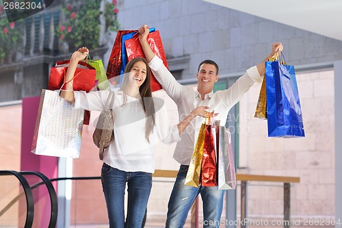 Image of happy young couple in shopping