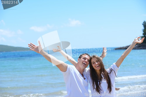 Image of happy couple have fun on the beach