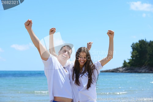 Image of happy couple have fun on the beach