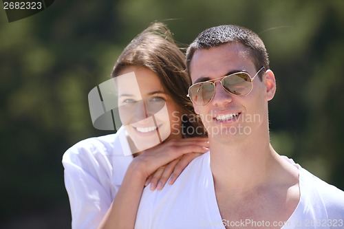 Image of happy couple have fun on the beach