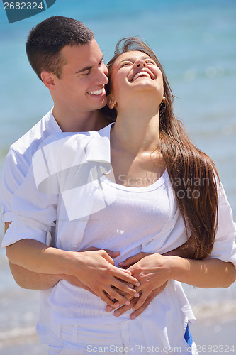 Image of happy couple have fun on the beach