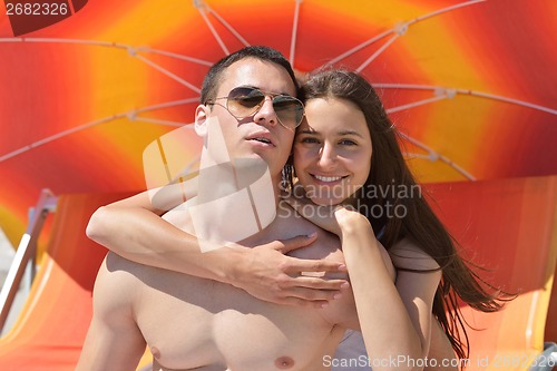 Image of happy couple have fun on the beach