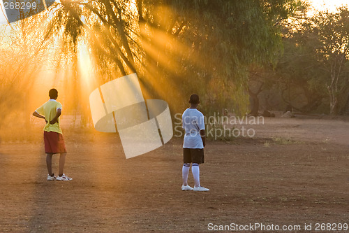 Image of players at the sunset