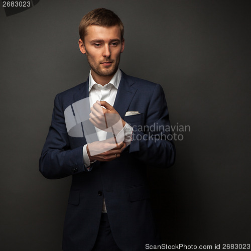 Image of handsome businessman on black