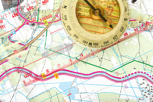 Image of old touristic compass on map 