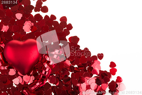 Image of small red confetti and big hearts on white background
