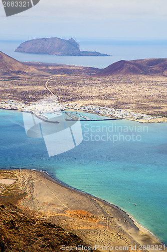 Image of miramar del rio harbor rock beach  boat     in lanzarote spain 