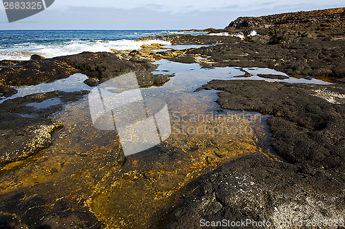 Image of beach  light  water   lanzarote foam rock spain    stone sky clo