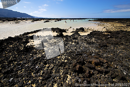 Image of people spain  hill white  beach  spiral of black    lanzarote 