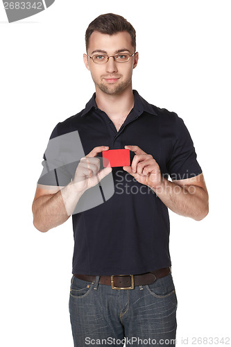 Image of Cheerful male showing red card in hand