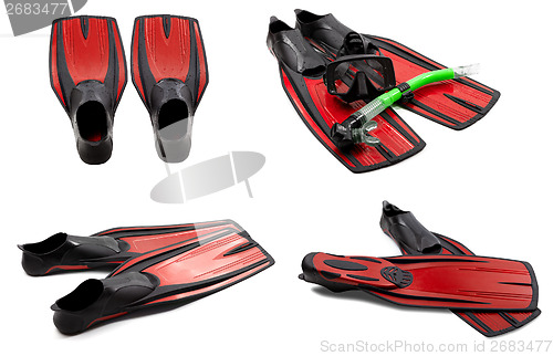 Image of Set of red swim fins, mask, snorkel for diving with water drops