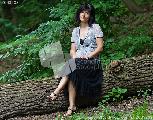 Image of Portrait of attractive brunette in park