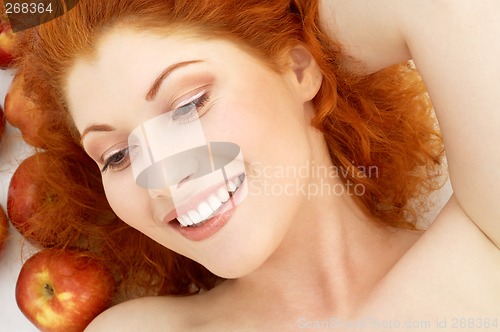 Image of lovely redhead with red apples