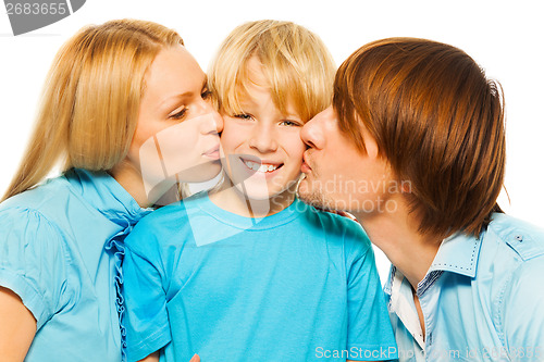 Image of Mother and father kiss boy