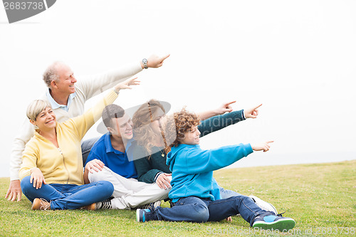 Image of Happy family pointing away