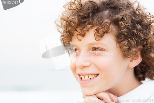 Image of Young pretty boy posing at beach