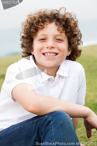 Image of Smiling young boy posing casually 