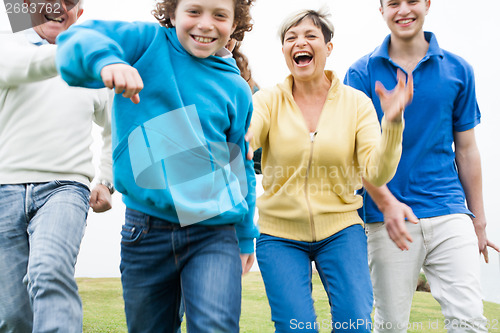 Image of Happy family playing on lawn