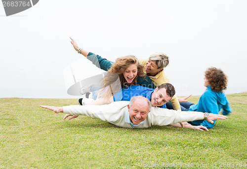 Image of Happy family playing at park