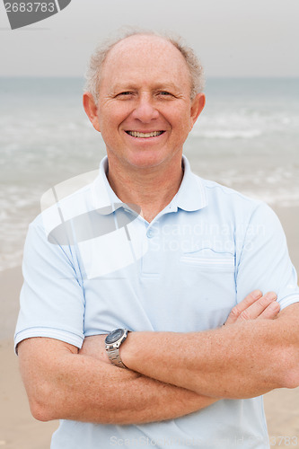 Image of Confident senior citizen posing at beach