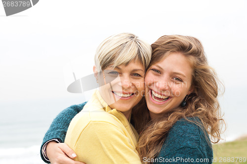 Image of Happy mother and daughter looking at camera