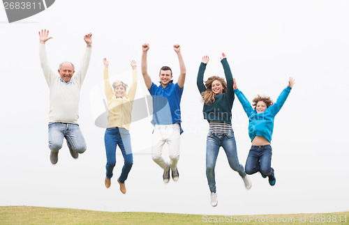 Image of Family jumping on the air at park