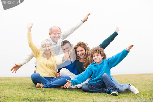 Image of Happy family playing in the grass