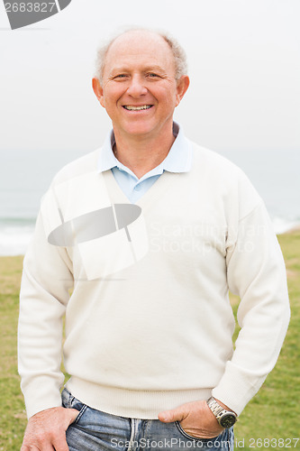 Image of Smiling aged man on grass land background