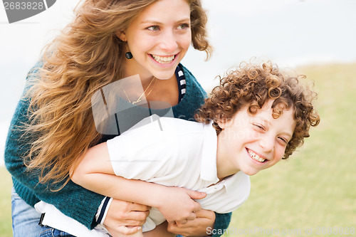 Image of Happy mother and son playing