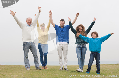 Image of Happy family raised their hands