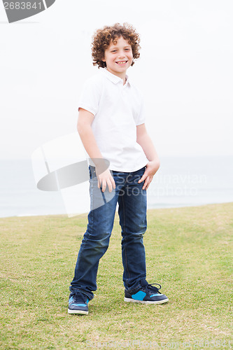 Image of Young boy posing with hand in pocket