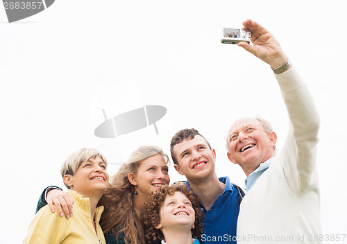 Image of Smiling family taking photos