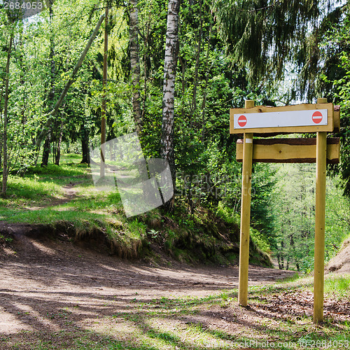 Image of Wooden sign board on the natural trail. In the 
 forest park