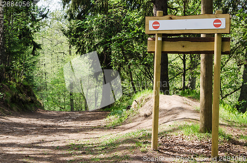 Image of Wooden sign board on the natural trail. In the 
 forest park