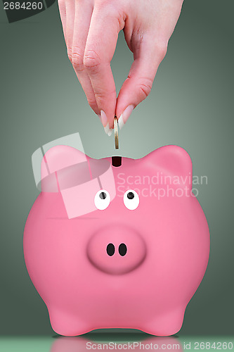 Image of Fingers and piggy bank